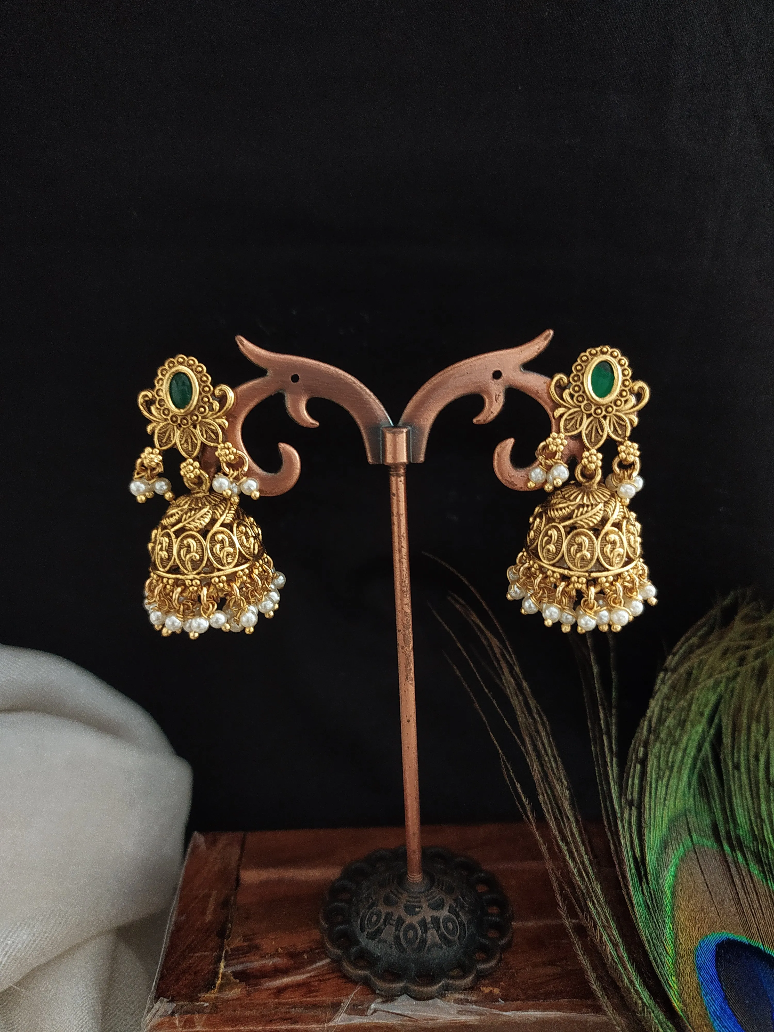 Floral Elegance Oval-Shape Studded Jhumki with Golden Ball Drops