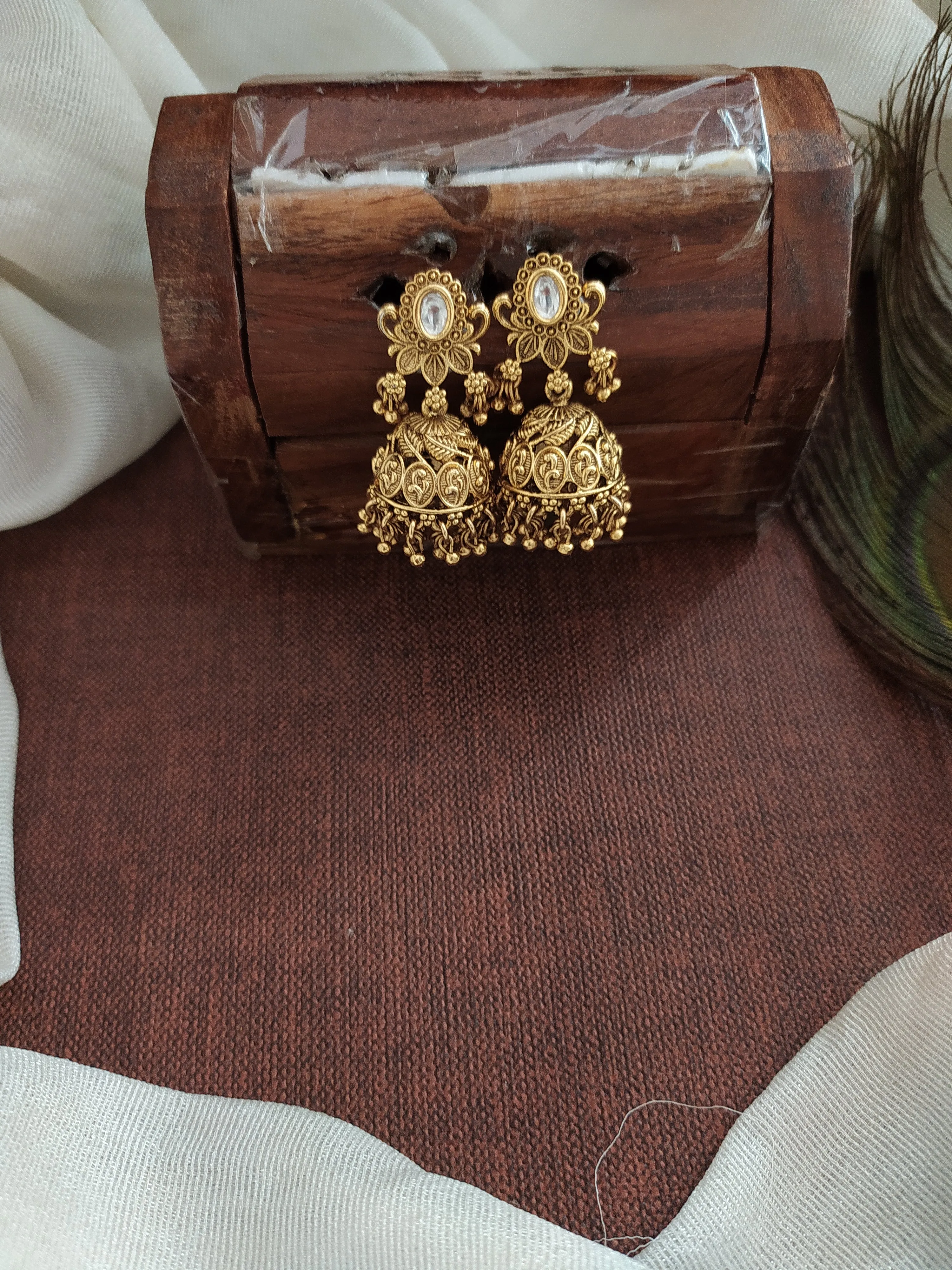 Floral Elegance Oval-Shape Studded Jhumki with Golden Ball Drops