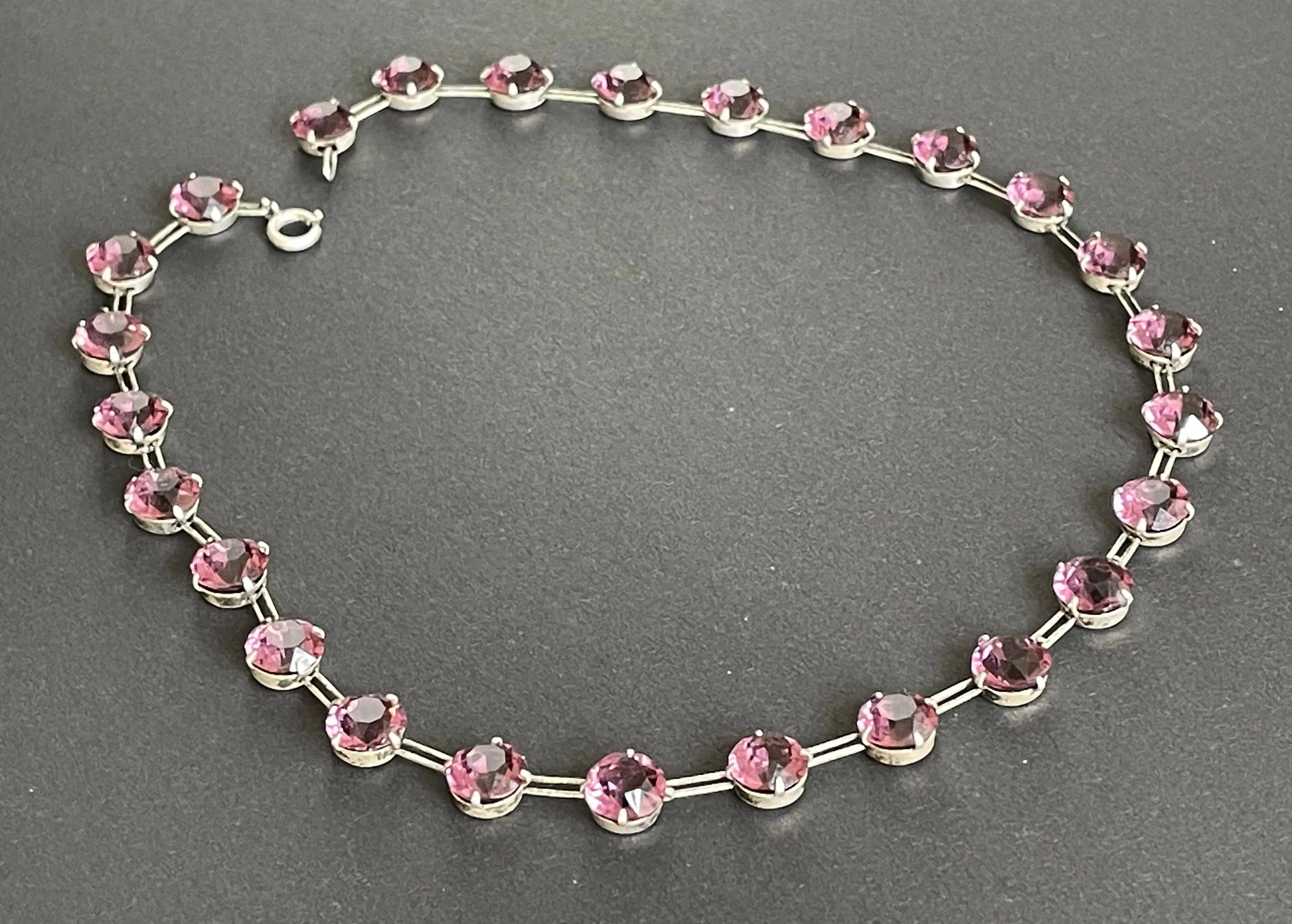 Vintage sterling silver Art Deco ruby pink / amethyst purple chaton cut crystal rhinestone riviere necklace bezel set, open backed, by W H Collins